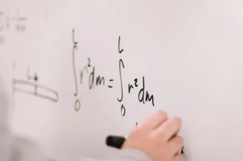 Physics and maths equations on whiteboard - representing Katie's expertise